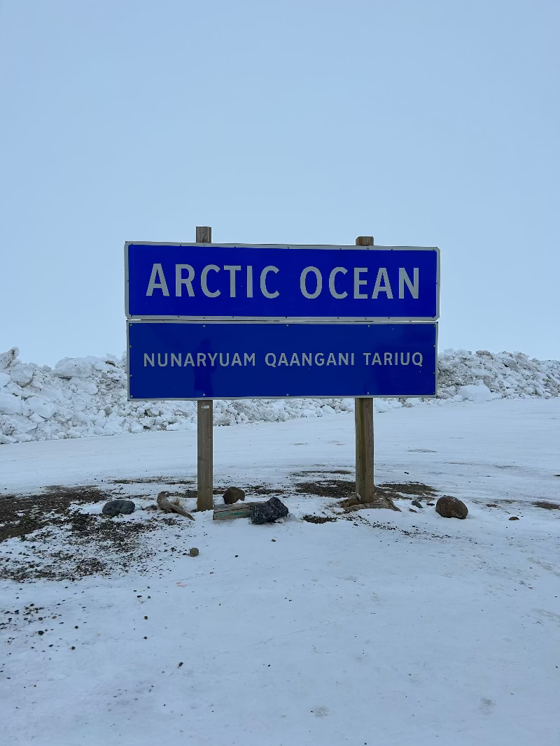 Blue sign indicating 'Arctic Ocean' in white text, with a snowy background.