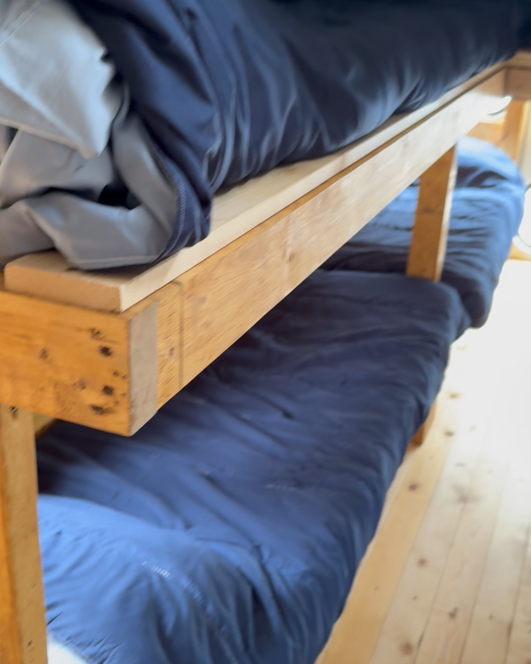 Bunk beds in cabin lodge on wheels converted school bus
