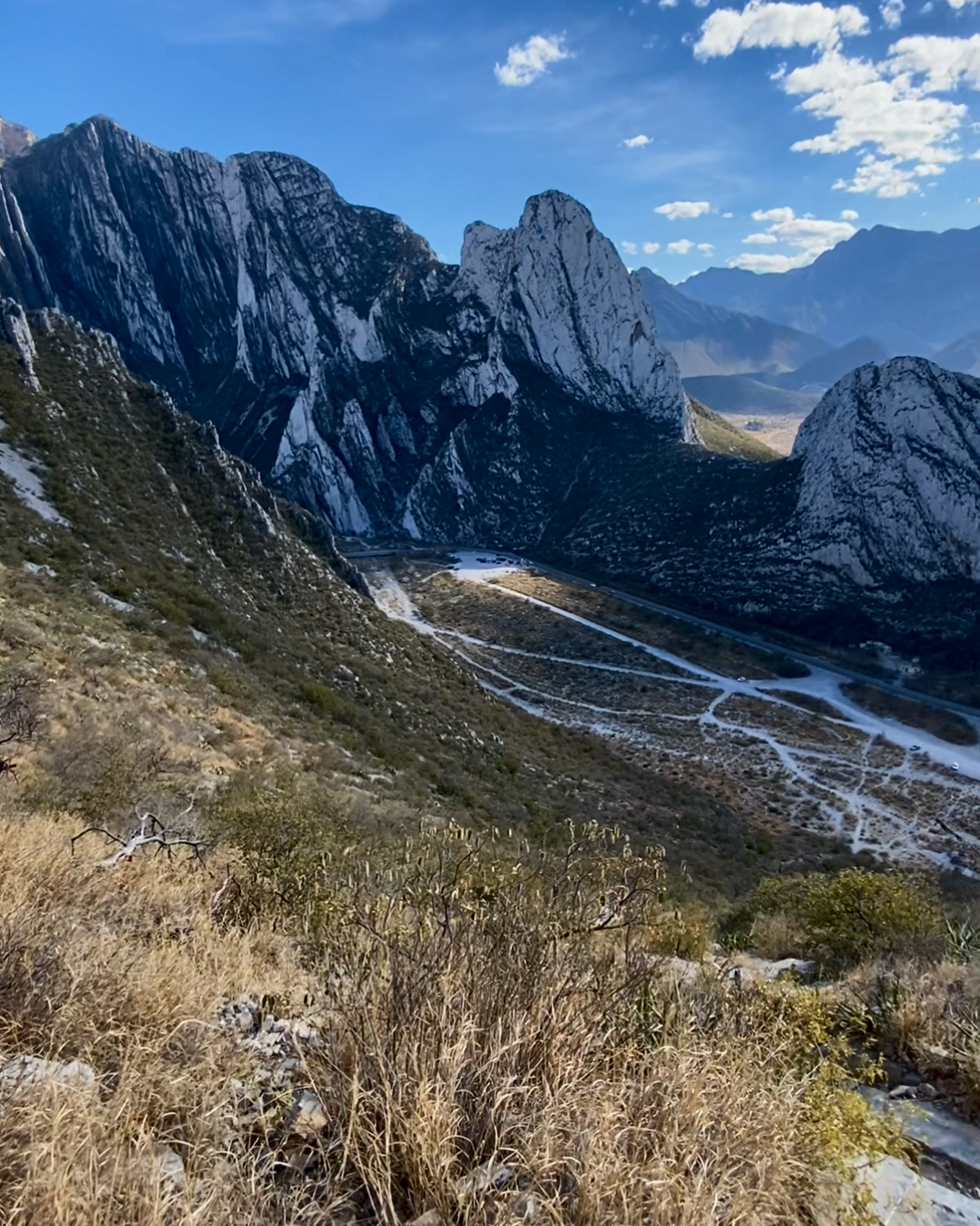 Mountainous landscape with rugged peaks and a clear blue sky.