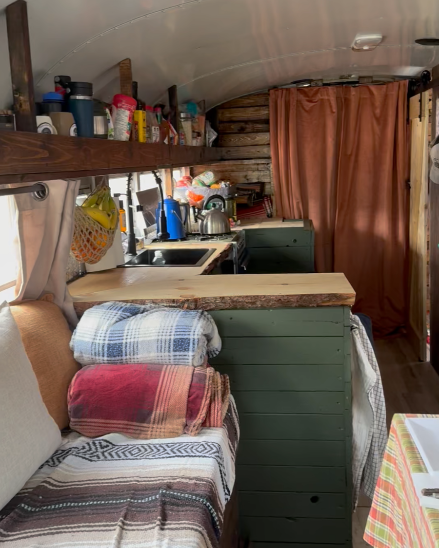 Kitchen and interior of converted skoolie for vanlife trips and ski basecamp