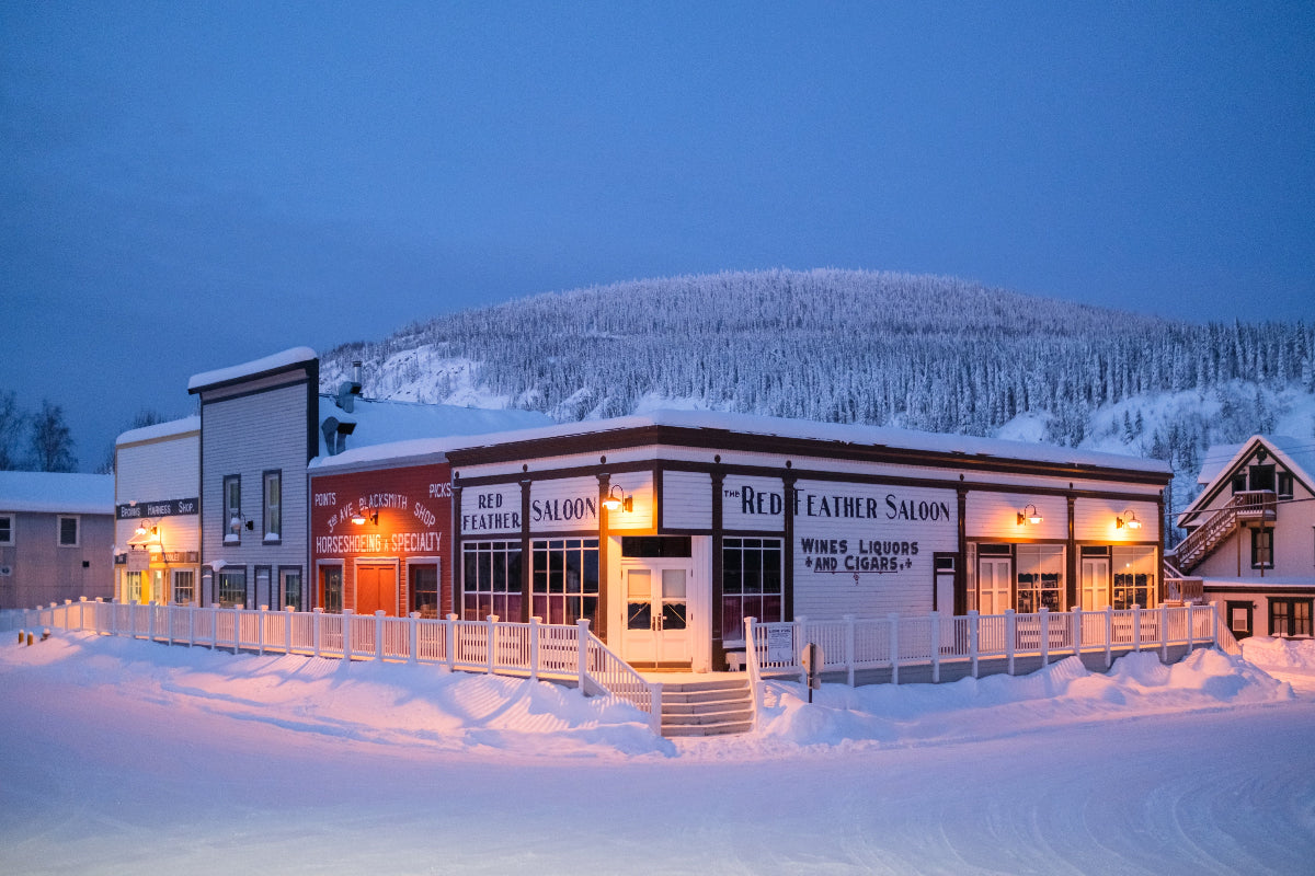 Saloon building in a snowy landscape at night, in Dawson City, Yukon Canada