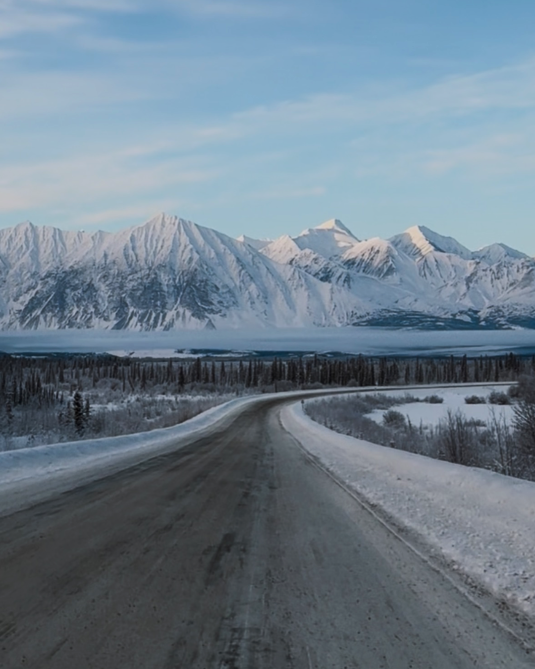 Driving down towards Haines Junction, mountains Kluane National Park in winter