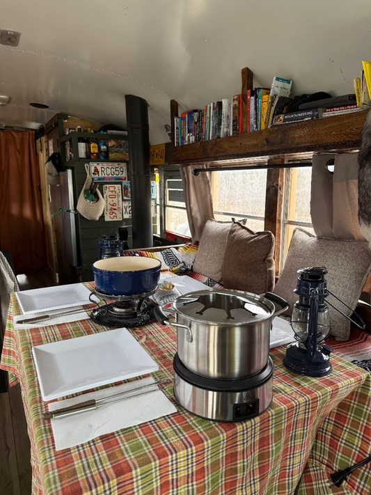 Cozy fondue night in converted skoolie, cabin on wheels