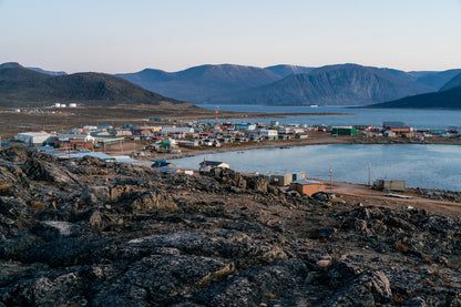 Dusk in a harsh arctic landscape with bare hills and ocean. Overlook of Inuit settlement of Qikiqtarjuaq, Broughton Island