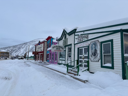 Old saloon style buildings with board walk in the winter with snow, Dawson City Yukon Canada.