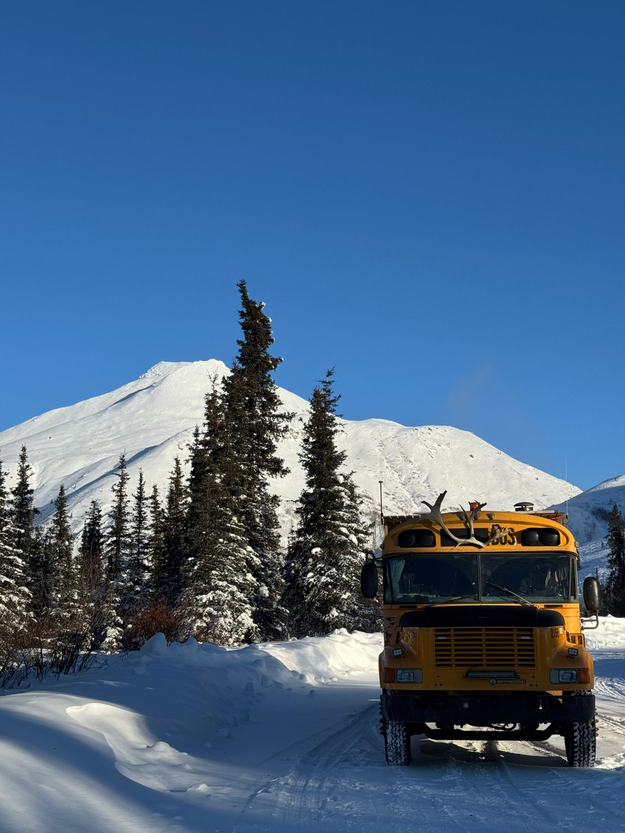 The Squatch bus on a snowy road in Tombstone Territorial Park