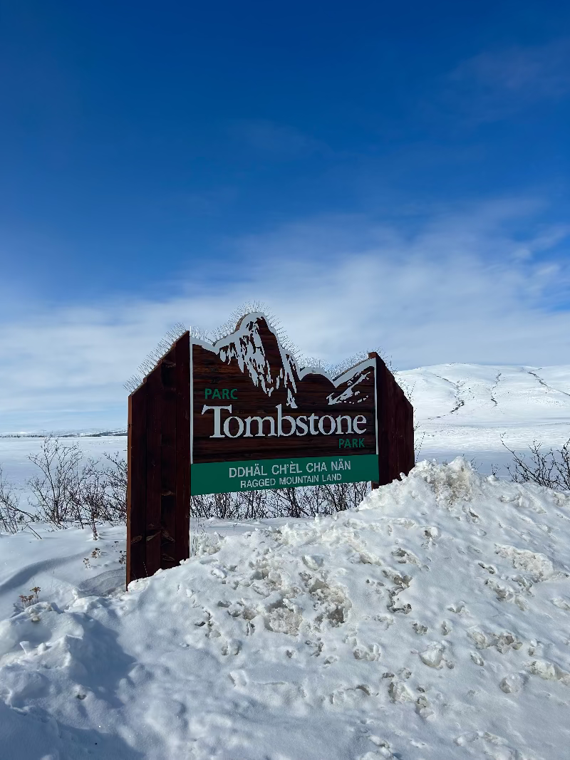 Sign for Tombstone Park in a snowy landscape in the winter.