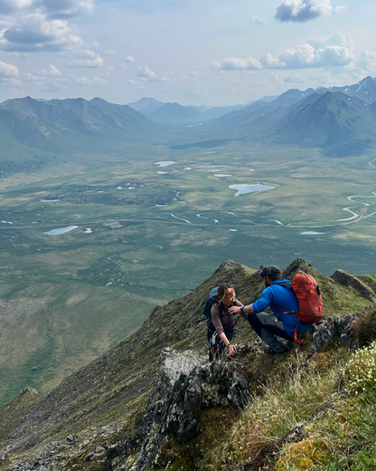 Hiker is guided scrambling up summit in Tombstone Yukon
