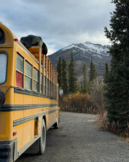 Squatch Bus parked as mobile basecamp in Yukon mountains